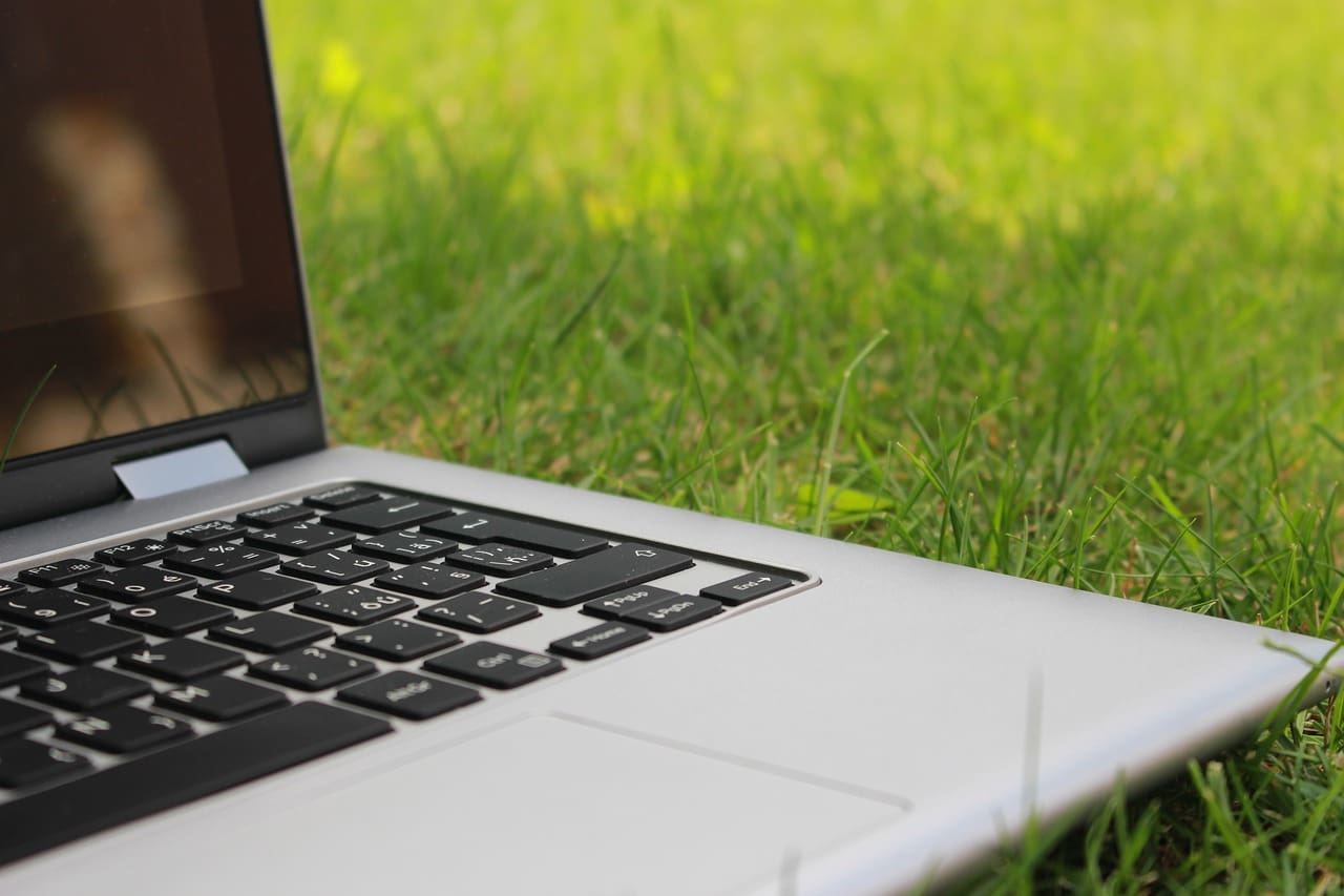 laptop sitting in grass